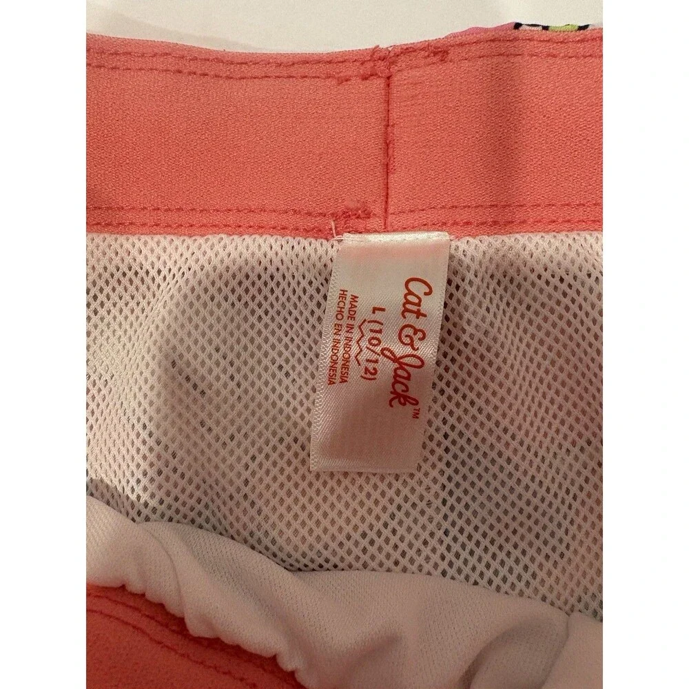 Cat & Jack boys' tropical dinosaur swim trunks feature a vibrant pink and orange